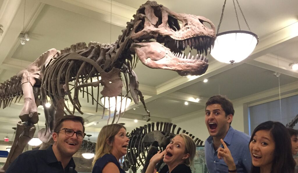 Players on a museum of natural history scavenger hunt find a T. rex.