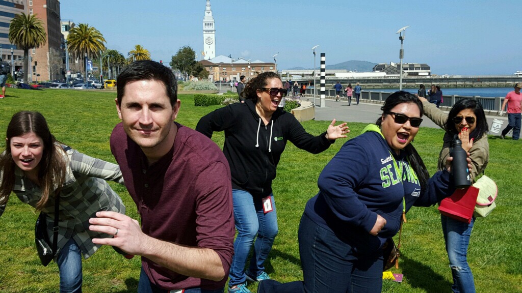 A group of players running around the Embarcadero for a corporate scavenger hunt game in San Francisco.