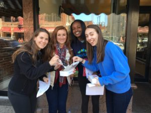 A team on a scavenger hunt in Boston's North End stop for a snack.