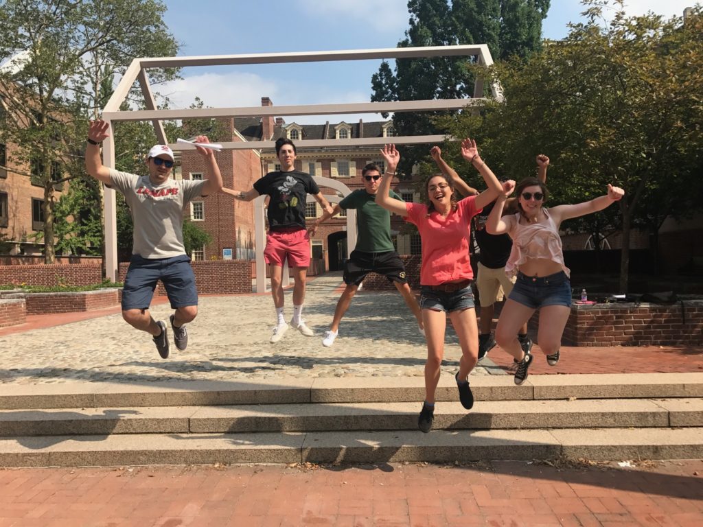 Team players in Philadelphia taking a group photo jumping in mid-air as part of a scavenger hunt